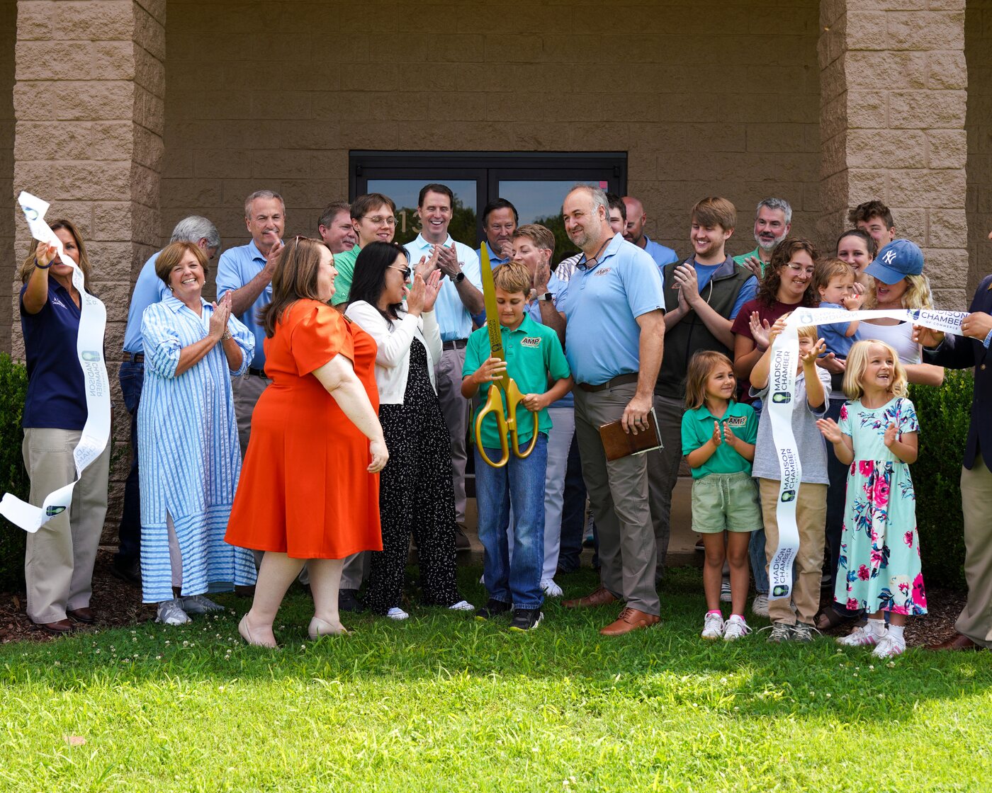 AMP employees and families at the Madison Chamber of Commerce ribbon cutting marking the C&E Design acquisition