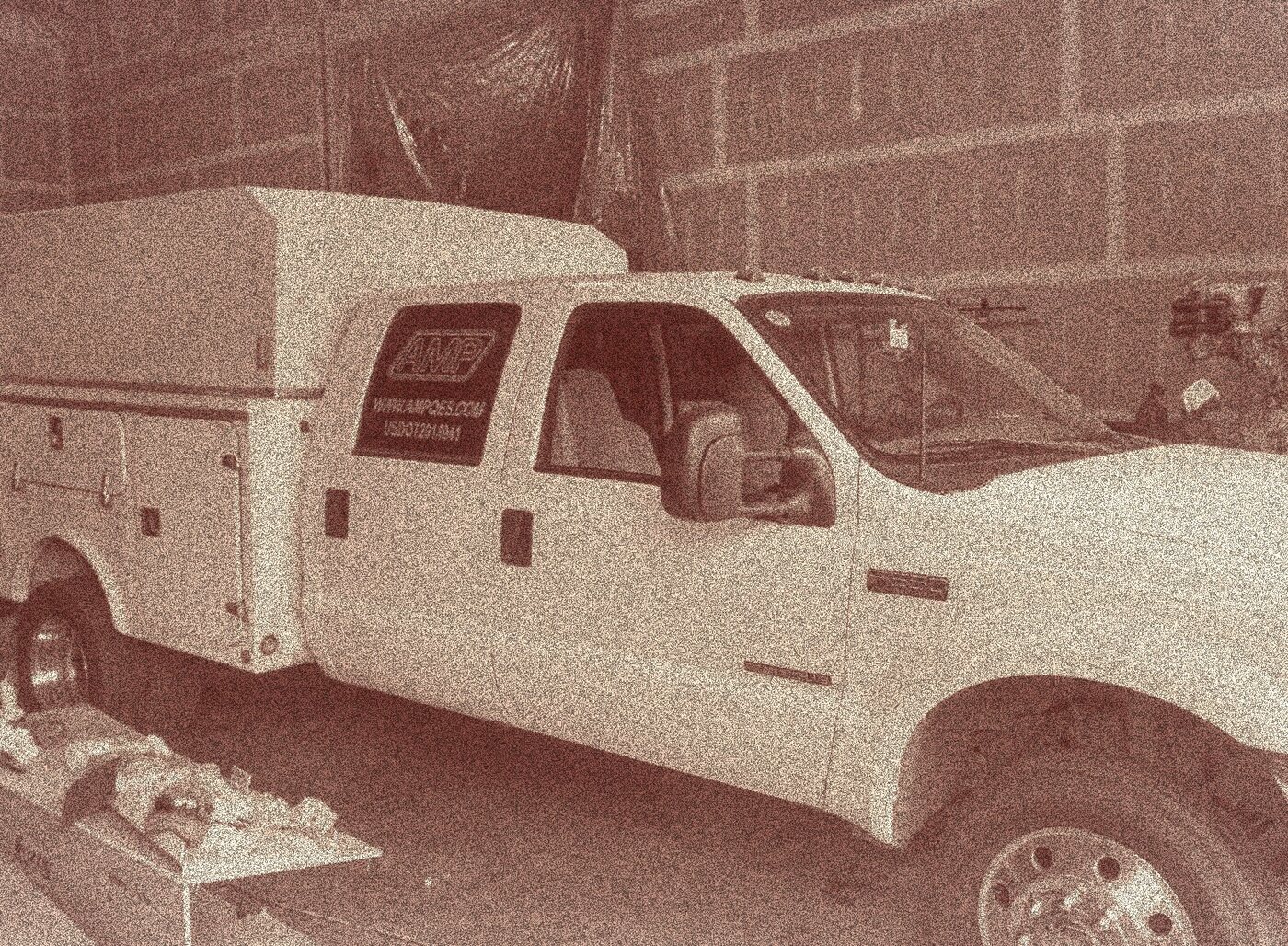 An early AMP service truck parked at a jobsite